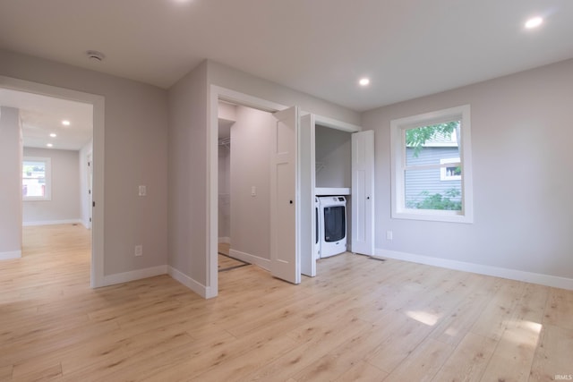 1026 S 35th St, South Bend, IN 46615 - unfurnished bedroom featuring washer / dryer, light wood-style floors, baseboards, recessed lighting, and a spacious closet