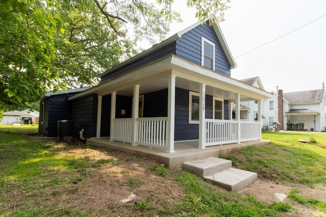 1026 S 35th St, South Bend, IN 46615 - view of side of home with covered porch, central air condition unit, and a yard