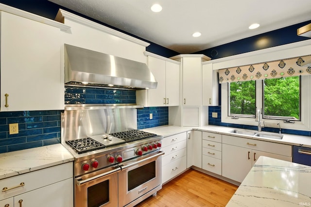 5905 Anjolea Way, Lafayette, IN 47905 - kitchen featuring a sink, wall chimney range hood, double oven range, tasteful backsplash, and white cabinets