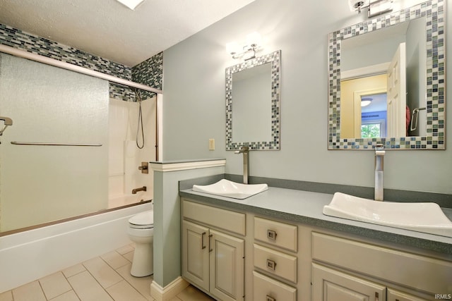 5905 Anjolea Way, Lafayette, IN 47905 - bathroom featuring tile patterned flooring, double vanity, toilet, bath / shower combo with glass door, and a textured ceiling