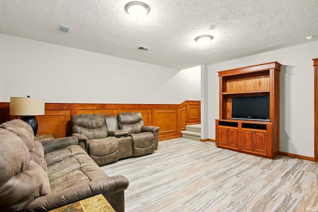 5905 Anjolea Way, Lafayette, IN 47905 - living room with light wood-style flooring, stairs, a textured ceiling, and wainscoting