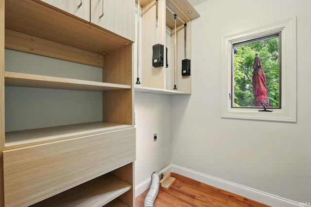 5905 Anjolea Way, Lafayette, IN 47905 - laundry room featuring hookup for an electric dryer, baseboards, cabinet space, and wood finished floors