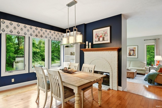 5905 Anjolea Way, Lafayette, IN 47905 - dining room featuring light wood-style flooring, baseboards, and a fireplace