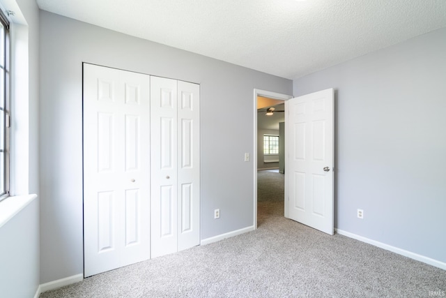 7914 Stonegate Pl, Fort Wayne, IN 46825 - unfurnished bedroom with carpet flooring, baseboards, a closet, and a textured ceiling