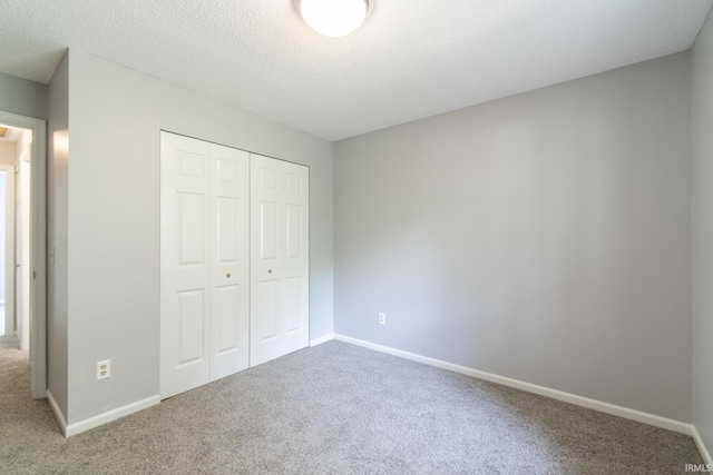 7914 Stonegate Pl, Fort Wayne, IN 46825 - unfurnished bedroom featuring carpet, a closet, baseboards, and a textured ceiling