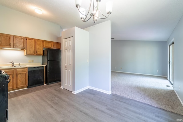 7914 Stonegate Pl, Fort Wayne, IN 46825 - kitchen with black appliances, a sink, light wood-style floors, and brown cabinetry