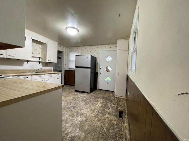 2405 Clara Ave, Fort Wayne, IN 46805 - kitchen featuring freestanding refrigerator, white cabinetry, a sink, and wooden counters