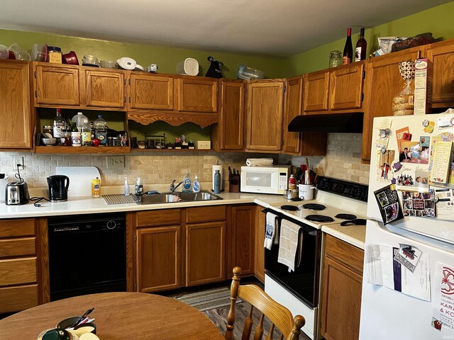 39 E Linn Rd, Bluffton, IN 46714 - kitchen featuring white appliances, under cabinet range hood, light countertops, brown cabinetry, and open shelves