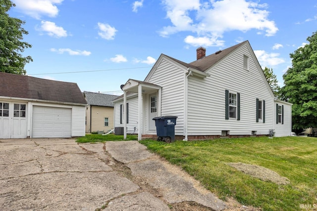 459 N Columbia St, Frankfort, IN 46041 - view of front of home with an outdoor structure, a chimney, concrete driveway, a front yard, and central AC unit