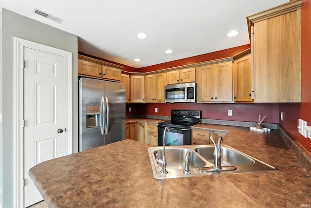 1328 Monte Carlo Dr, Huntertown, IN 46748 - kitchen featuring appliances with stainless steel finishes, a sink, a peninsula, recessed lighting, and dark countertops