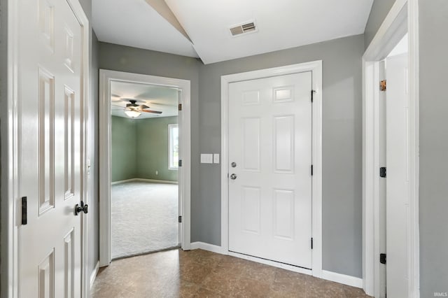 1328 Monte Carlo Dr, Huntertown, IN 46748 - foyer entrance featuring baseboards, a ceiling fan, carpet, and tile patterned flooring