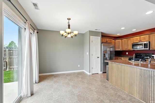 1328 Monte Carlo Dr, Huntertown, IN 46748 - kitchen featuring appliances with stainless steel finishes, a chandelier, baseboards, hanging light fixtures, and recessed lighting