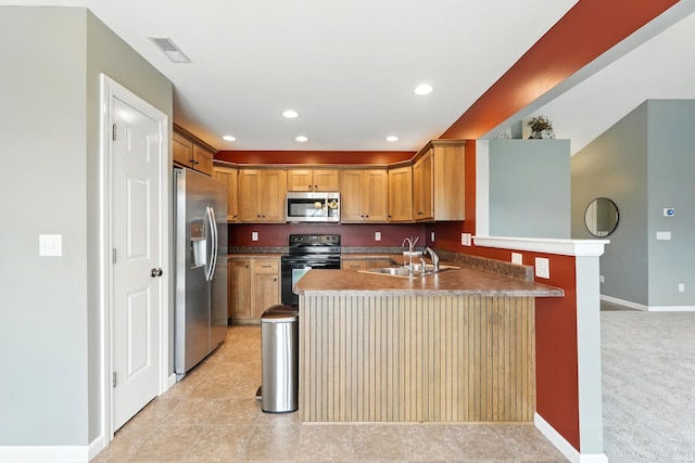 1328 Monte Carlo Dr, Huntertown, IN 46748 - kitchen with appliances with stainless steel finishes, a sink, a peninsula, baseboards, and recessed lighting