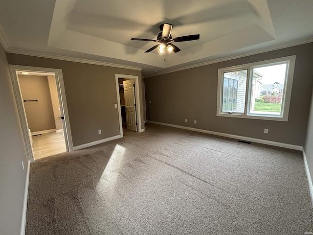 10403 Maple Springs Cv, Fort Wayne, IN 46845 - unfurnished bedroom featuring a raised ceiling, ornamental molding, carpet floors, baseboards, and a walk in closet