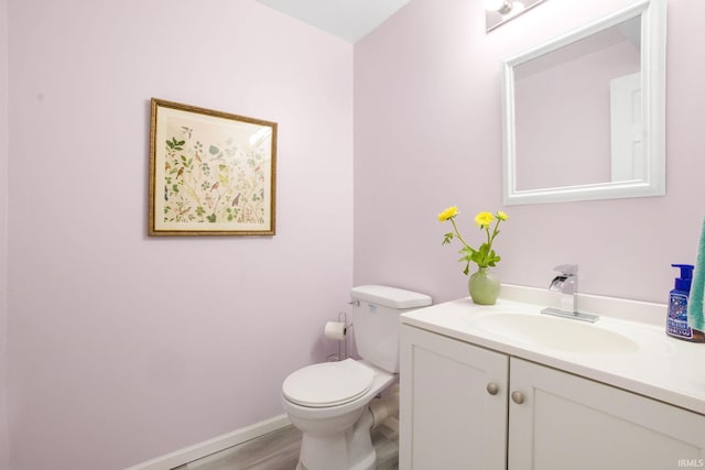 515 Cloudmont Dr, Osceola, IN 46561 - bathroom featuring vanity, toilet, wood finished floors, and baseboards