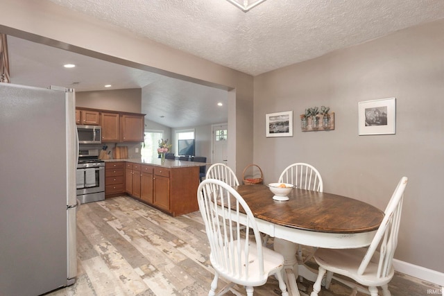 53722 Bittersweet Rd, Mishawaka, IN 46545 - dining room featuring lofted ceiling, light wood-style floors, a textured ceiling, recessed lighting, and baseboards