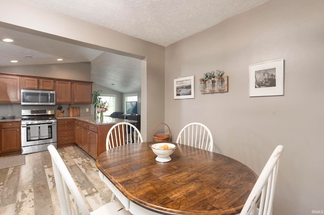 53722 Bittersweet Rd, Mishawaka, IN 46545 - dining space featuring vaulted ceiling, light wood finished floors, recessed lighting, and a textured ceiling