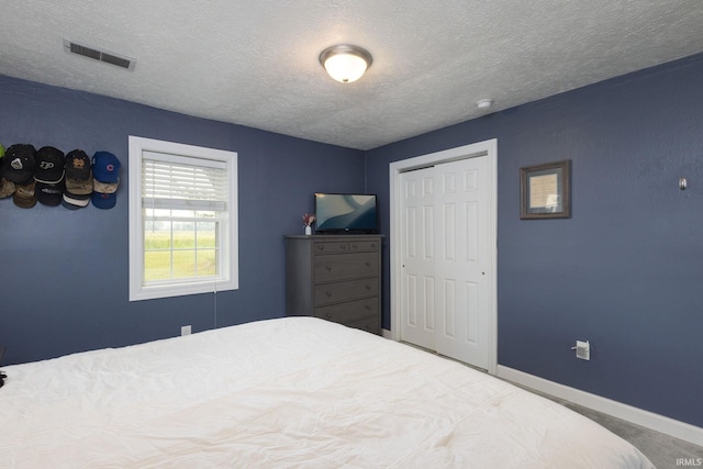 53722 Bittersweet Rd, Mishawaka, IN 46545 - bedroom with a textured ceiling, a closet, and baseboards