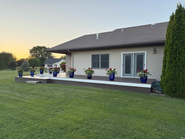 530 W 060 N, Lagrange, IN 46761 - back of property at dusk with a shingled roof, a lawn, and a deck