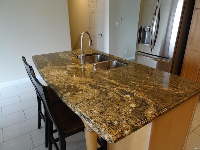 530 W 060 N, Lagrange, IN 46761 - kitchen featuring stainless steel fridge with ice dispenser, a sink, a large island with sink, dark stone counters, and light tile patterned flooring