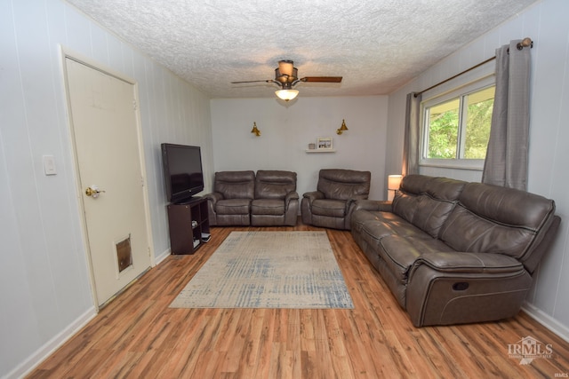 2318 W Concord Rd, Muncie, IN 47304 - living room featuring wood finished floors, a textured ceiling, and ceiling fan