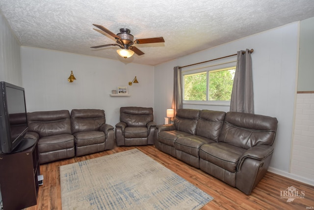 2318 W Concord Rd, Muncie, IN 47304 - living room with wood finished floors, ceiling fan, and a textured ceiling