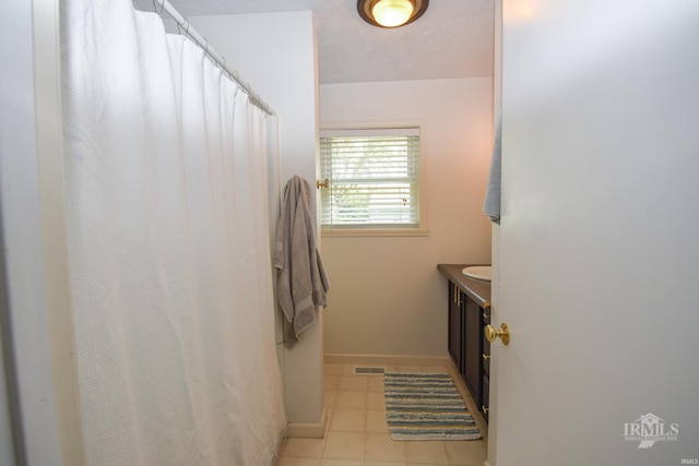 2318 W Concord Rd, Muncie, IN 47304 - bathroom with vanity, tile patterned flooring, baseboards, and a shower with shower curtain