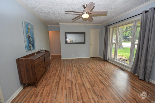 2318 W Concord Rd, Muncie, IN 47304 - unfurnished room featuring wood finished floors, a textured ceiling, a ceiling fan, baseboards, and crown molding