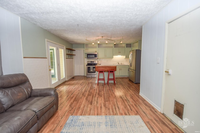 2318 W Concord Rd, Muncie, IN 47304 - living area with light wood-style floors and a textured ceiling