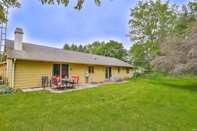 1402 Ivy Ct, North Manchester, IN 46962 - rear view of property featuring a patio area, a yard, and a chimney