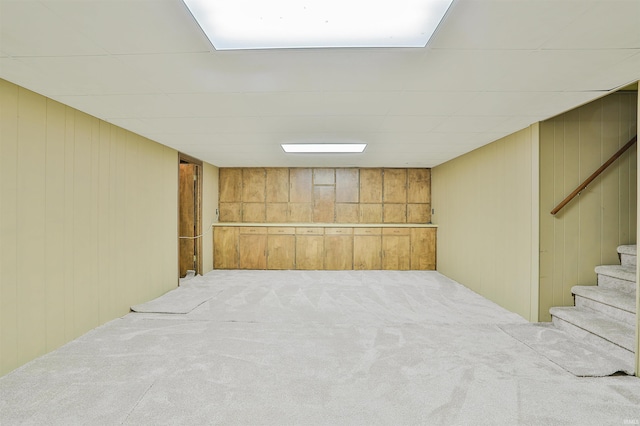 1402 Ivy Ct, North Manchester, IN 46962 - finished below grade area featuring carpet flooring, wood walls, and stairs