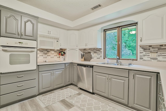 1402 Ivy Ct, North Manchester, IN 46962 - kitchen featuring white appliances, a sink, gray cabinets, a textured ceiling, and light countertops