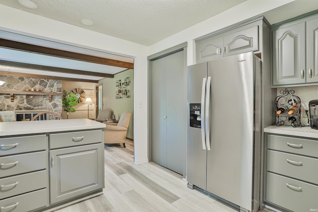 1402 Ivy Ct, North Manchester, IN 46962 - kitchen with stainless steel fridge with ice dispenser, gray cabinets, beam ceiling, light wood-type flooring, and open floor plan