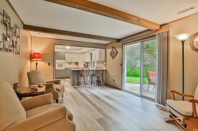 1402 Ivy Ct, North Manchester, IN 46962 - living area with beam ceiling, light wood-type flooring, a textured ceiling, and ornamental molding