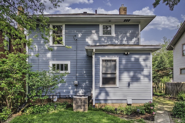 4321 Arlington Ave, Fort Wayne, IN 46807 - back of house with central air condition unit and a chimney