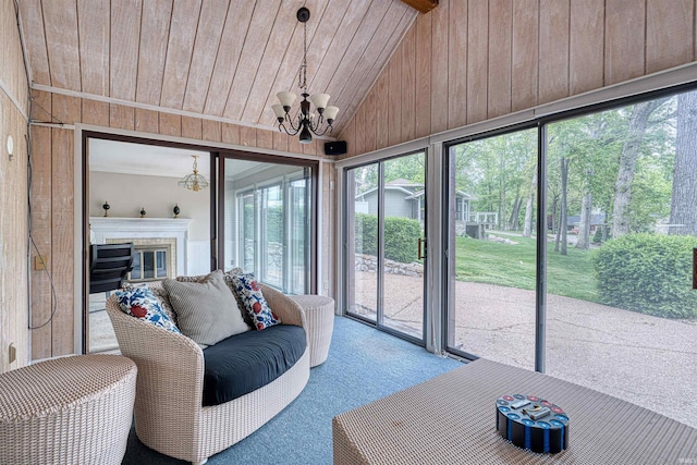 6888 Miller Ln, Newburgh, IN 47630 - sunroom featuring a chandelier, lofted ceiling, and a glass covered fireplace