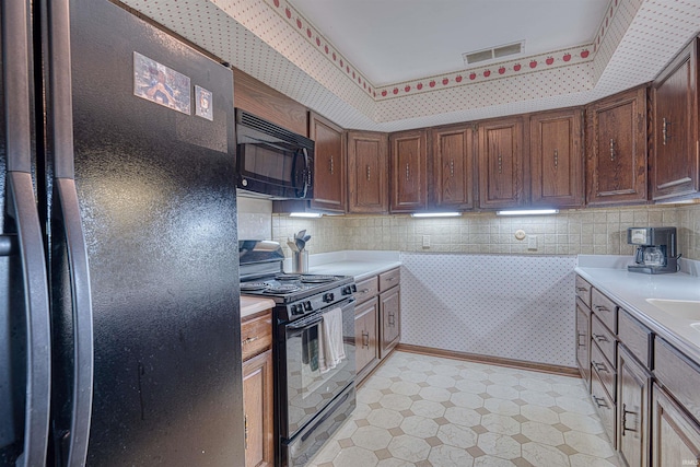 6888 Miller Ln, Newburgh, IN 47630 - kitchen with black appliances, light flooring, light countertops, and backsplash