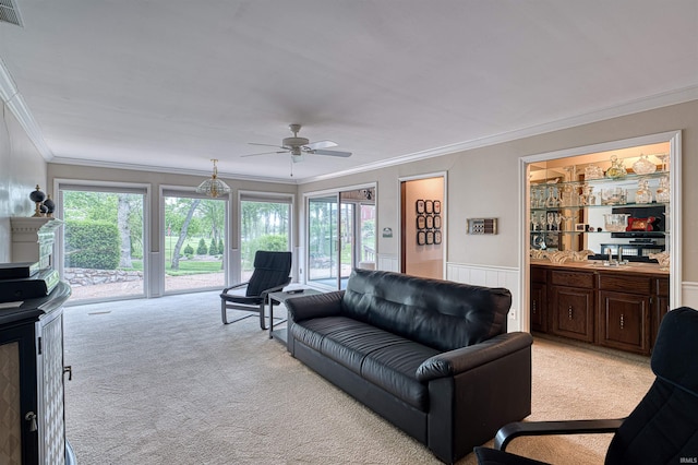 6888 Miller Ln, Newburgh, IN 47630 - living room with light colored carpet, ornamental molding, ceiling fan, plenty of natural light, and wainscoting