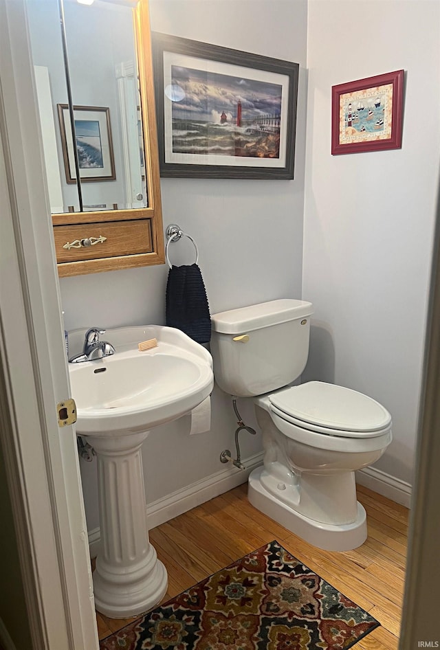 1976 Oak St, Linton, IN 47441 - half bathroom featuring wood finished floors, toilet, and baseboards