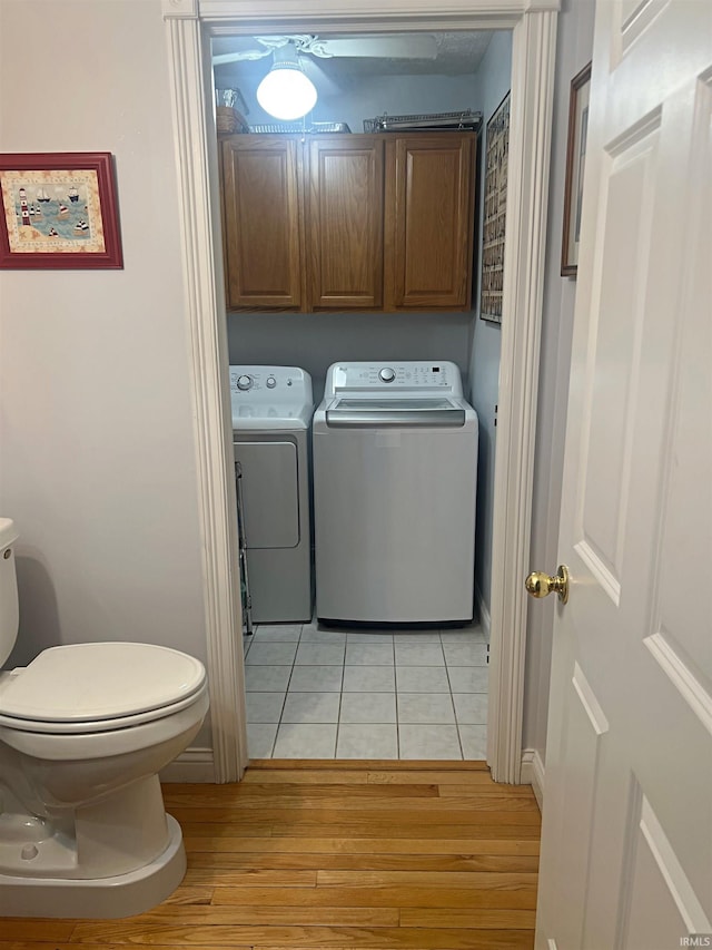 1976 Oak St, Linton, IN 47441 - laundry room with separate washer and dryer, cabinet space, light wood-style flooring, and baseboards