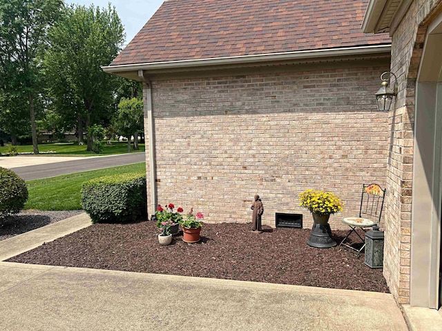 1976 Oak St, Linton, IN 47441 - exterior view of gutters, a downspout, brick siding, and roof with shingles