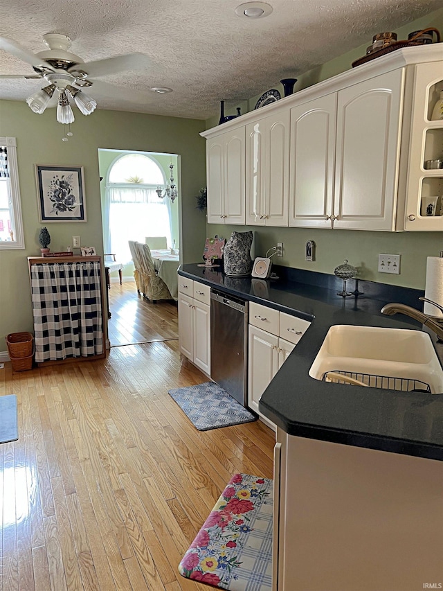1976 Oak St, Linton, IN 47441 - kitchen with dishwasher, dark countertops, a sink, light wood-style flooring, and a textured ceiling