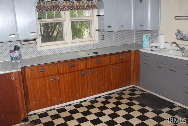 135 S Broad St, Dunkirk, IN 47336 - kitchen featuring tile patterned floors, a sink, tasteful backsplash, and light countertops