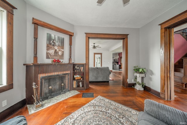 201 S 11th St, New Castle, IN 47362 - living room featuring ceiling fan, a fireplace, wood finished floors, and baseboards