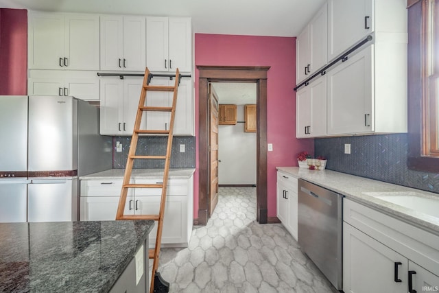 201 S 11th St, New Castle, IN 47362 - kitchen featuring appliances with stainless steel finishes, white cabinets, backsplash, dark stone counters, and a sink