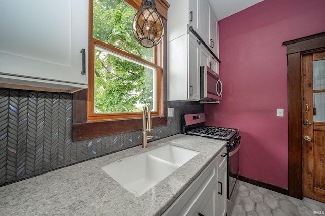 201 S 11th St, New Castle, IN 47362 - kitchen with appliances with stainless steel finishes, a sink, and white cabinets