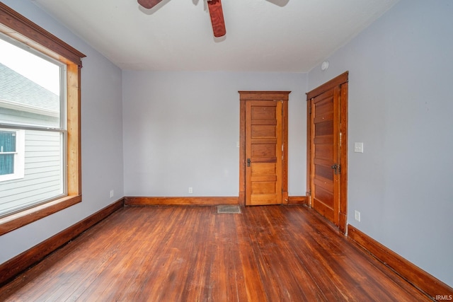 201 S 11th St, New Castle, IN 47362 - empty room with dark wood-style flooring, ceiling fan, healthy amount of natural light, and baseboards