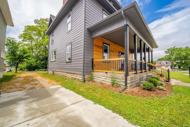 201 S 11th St, New Castle, IN 47362 - view of home's exterior featuring covered porch and a chimney