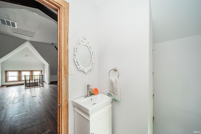 201 S 11th St, New Castle, IN 47362 - bathroom featuring wood finished floors, vanity, and vaulted ceiling