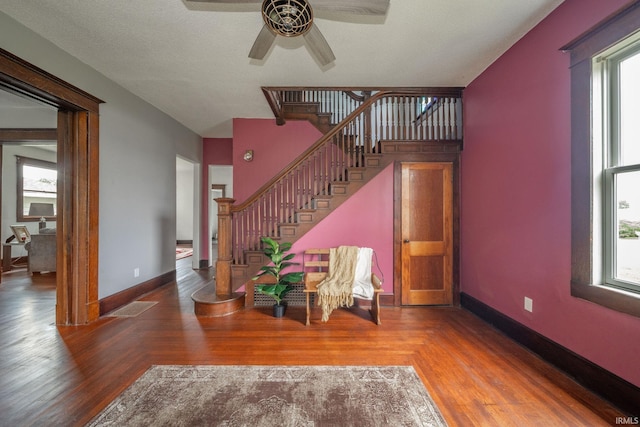 201 S 11th St, New Castle, IN 47362 - stairway featuring ceiling fan, plenty of natural light, and wood finished floors